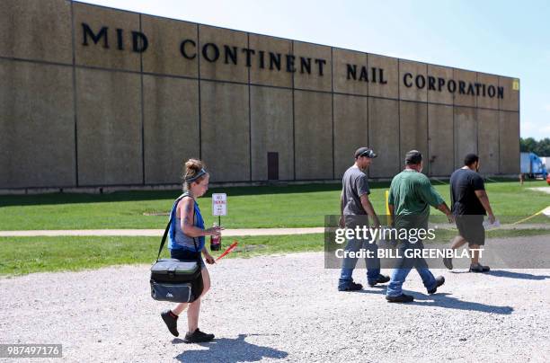 Workers leave the Mid Continent Nail Corporation after their shift, where customers have stopped placing orders in favor of cheaper imports of nails,...