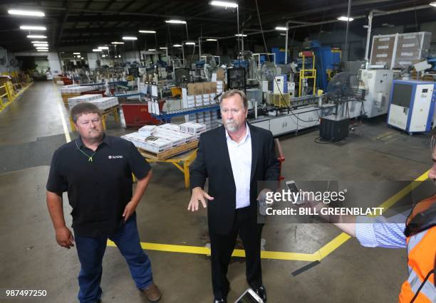 Mid Continent Nail Corporation's George Skarich, Vice President of Sales and Chris Pratt, CFO, talk to reporters in a production plant that has been...