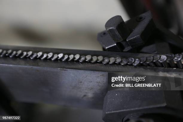 Nails sit in an ideled machine are seen at the Mid Continent Nail Corporation where customers have stopped placing orders in favor of cheaper imports...