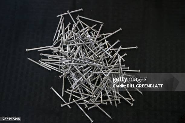Pile of nails is seen on a table at the Mid Continent Nail Corporation where customers have stopped placing orders in favor of cheaper imports of...
