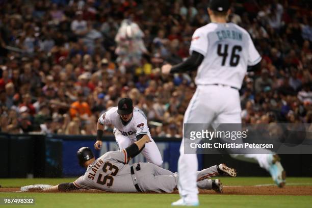 Infielder Jake Lamb of the Arizona Diamondbacks tags out Austin Slater of the San Francisco Giants during the second inning of the MLB game at Chase...