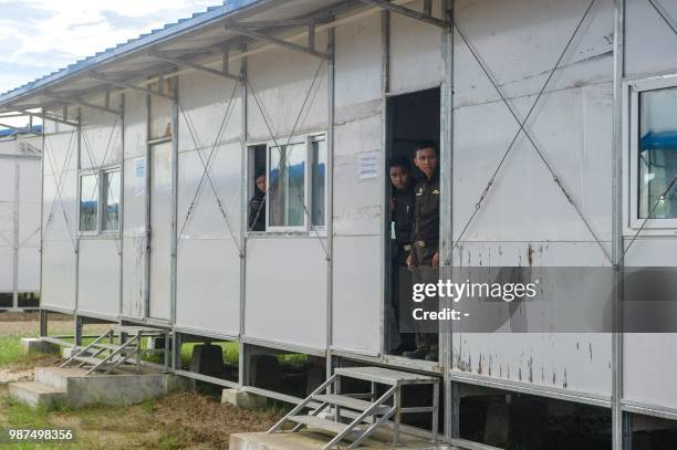 In this picture taken on June 28, 2018 Myanmar immigration officers are seen at Nga Khu Ra transit camp for Rohingya refugees in Maungdaw, Rakhine...