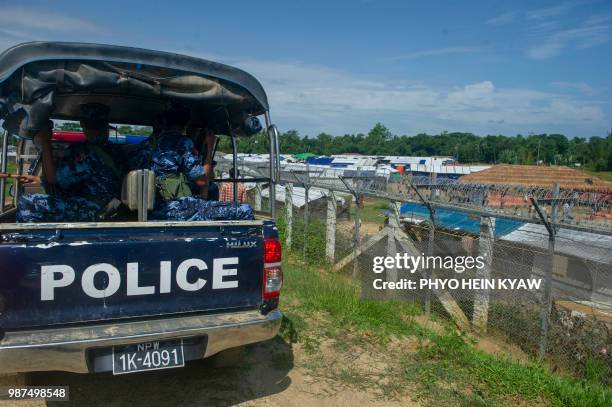 Myanmar border guard policemen patrol along the border between Myanmar and Bangladesh in Maungdaw, Rakhine state, on June 29, 2018. - Fewer than 200...