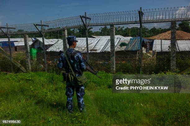 Myanmar border guard policeman patrols along the border between Myanmar and Bangladesh in Maungdaw, Rakhine state, on June 29, 2018. - Fewer than 200...