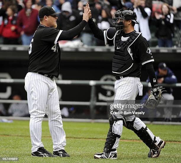 Bobby Jenks celebrates with A.J. Pierzynski of the Chicago White Sox after the game against the Seattle Mariners on Sunday, April 25 at U.S. Cellular...