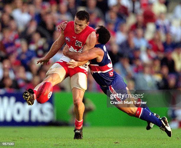 Jared Crouch for Sydney is tackled by Tony Liberatore for the Western Bulldogs during round eight of the AFL season match played between the Sydney...