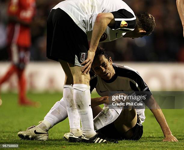 Simon Davies of Fulham holds his leg after he scores his teams first goal during the UEFA Europa League Semi-Final 2nd leg match between Fulham and...