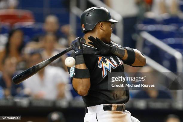 Starlin Castro of the Miami Marlins attempts to avoid a inside pitch against the New York Mets at Marlins Park on June 29, 2018 in Miami, Florida.