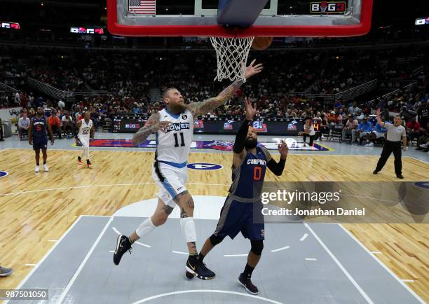 Chris Andersen of Power lays the ball up against Drew Gooden of 3's Company during week two of the BIG3 three on three basketball league at United...