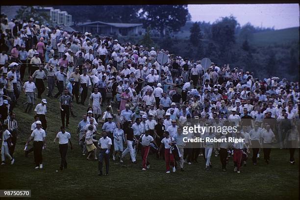 Arnold Palmer walks the course followed by "Arnie's Army" during the 1965 PGA Championship at Laurel Valley Golf Club in August 1965 in Ligonier,...