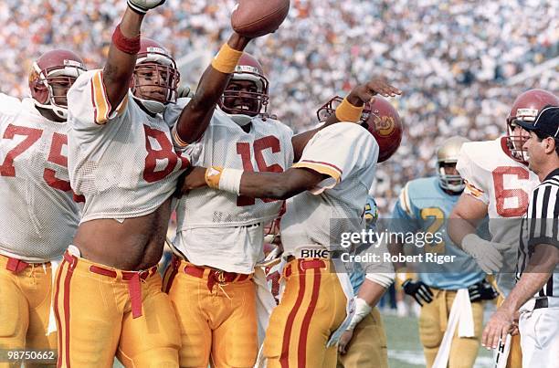 Mark Tucker, Scott Galbraith, Rodney Peete and John Jackson of the USC Trojans celebrate Peete's one yard touchdown run against the UCLA Bruins at...