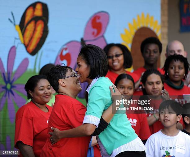 First Lady Michelle Obama and Congressional spouses help to paint a mural and plant a butterfly garden on April 28, 2010 at the Marie Reed Community...