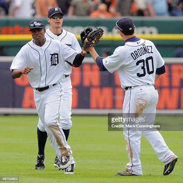 Austin Jackson, Don Kelly, and Magglio Ordonez of the Detroit Tigers celebrate the victory against the Minnesota Twins at Comerica Park on April 29,...