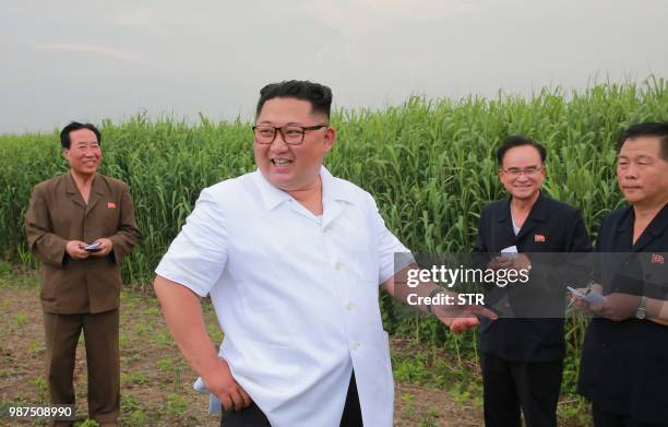 This undated and undisclosed picture released by Korean Central News Agency via KNS shows North Korean leader Kim Jong Un inspecting a farm in Sindo...