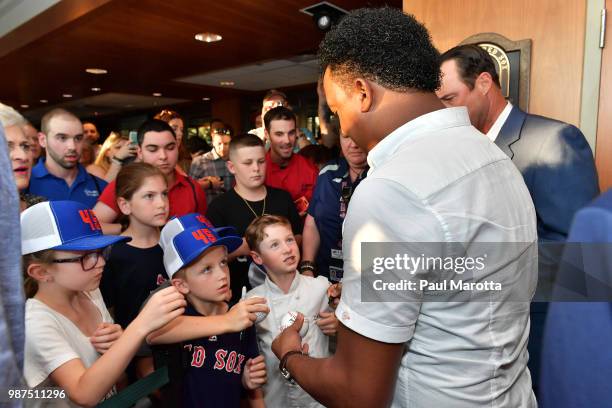 Pedro Martinez signs autographs for young fans at the Pedro Martinez Charity Feast With 45 at Fenway Park on June 29, 2018 in Boston, Massachusetts.