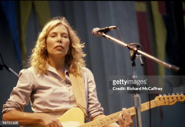 October 4: L-R Joni Mitchell performs live at at The Bread and Roses Festival at The Greek Theatre on October 4, 1980 in Berkeley, California.