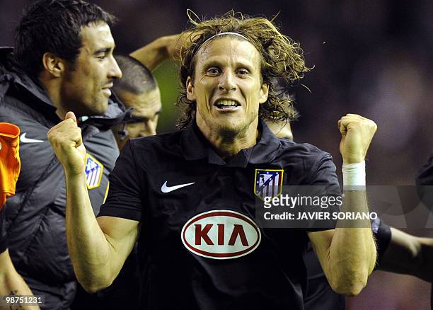 Atletico Madrid's Uruguayan forward Diego Forlan celebrates at the final whistle after his goal had knocked out Liverpool on away goals during their...
