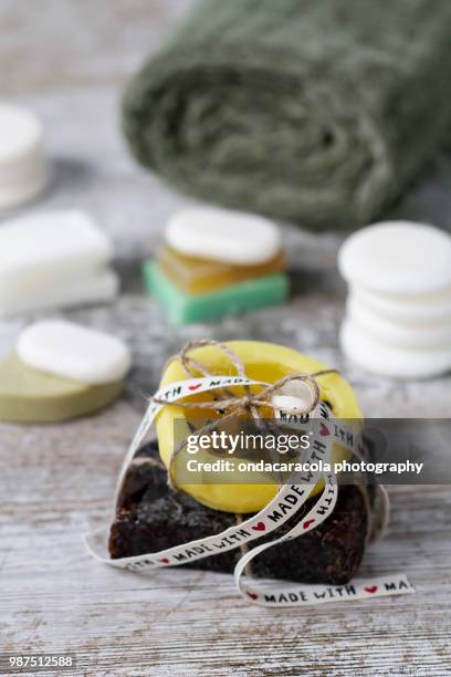 natural soaps over a rustic background - homemade soap stock pictures, royalty-free photos & images