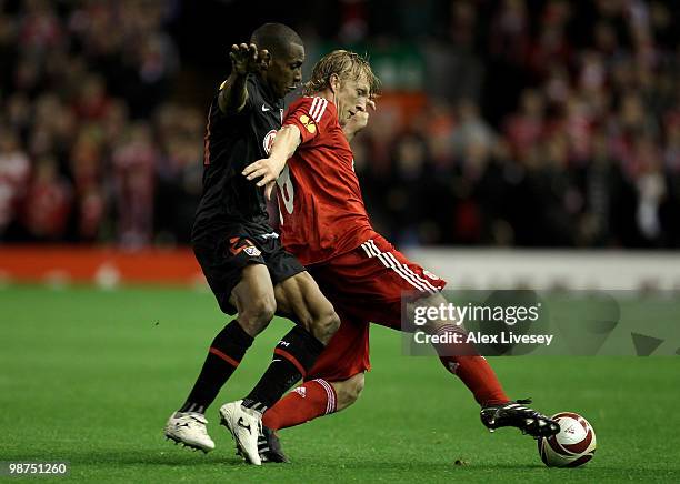 Luis Perea of Atletico Madrid battles for the ball with Dirk Kuyt of Liverpool during the UEFA Europa League Semi-Final Second Leg match between...