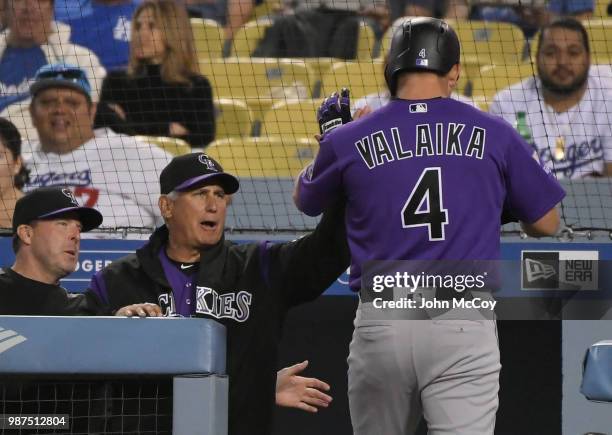 Bud Black Manager of the Colorado Rockies congratulates Pat Valaika on his fifth inning homre run against the Los Angeles Dodgers at Dodger Stadium...