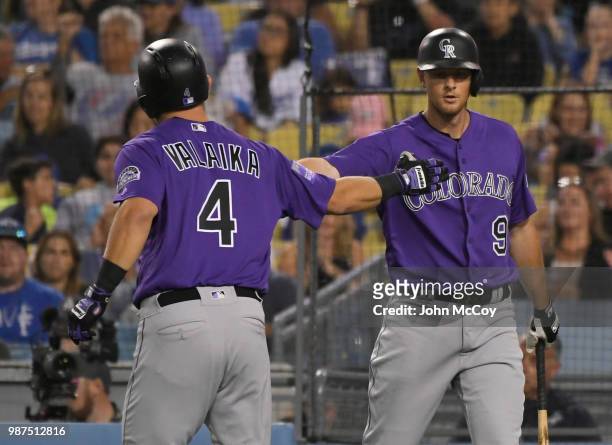 Pat Valaika is congratulated by DJ LeMahieu of the Colorado Rockies after hitting a home run in the fifth inning against the Los Angeles Dodgers at...