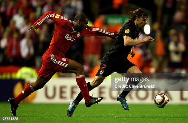 Juan Valera of Atletico Madrid evades the challenge of Ryan Babel of Liverpool during the UEFA Europa League Semi-Final Second Leg match between...