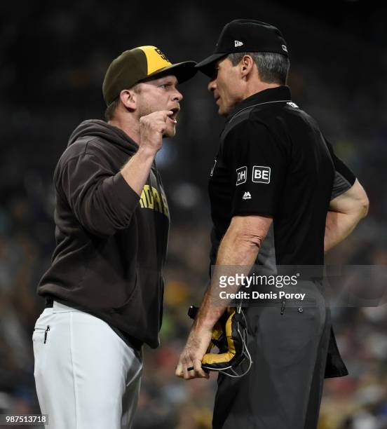 Andy Green of the San Diego Padres argues with home plate umpire Angel Hernandez after being thrown out of the game during the fourth inning of a...