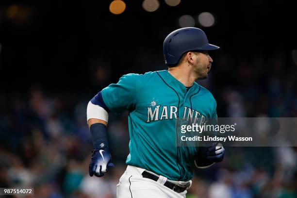 Mike Zunino of the Seattle Mariners watches his home run clear the fences in the fifth inning against the Kansas City Royals at Safeco Field on June...