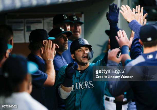 Mike Zunino of the Seattle Mariners is greeted in the dugout after hitting a home run off of Ian Kennedy of the Kansas City Royals in the fifth...