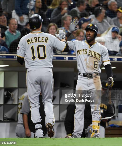 Jordy Mercer of the Pittsburgh Pirates is congratulated by Starling Marte after hitting a solo home run during the fourth inning of a baseball game...