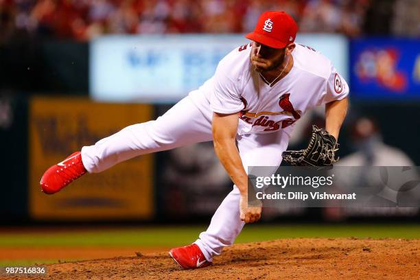 Greg Holland of the St. Louis Cardinals delivers a pitch against the Atlanta Braves in the eighth inning at Busch Stadium on June 29, 2018 in St....