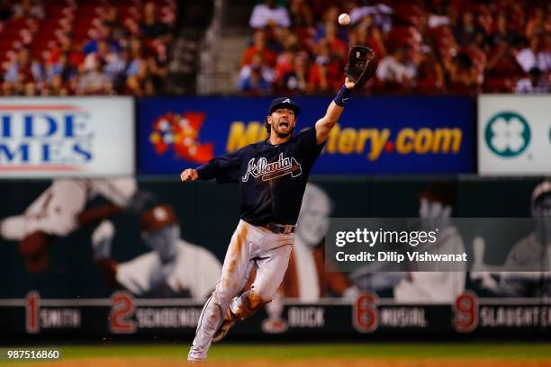 Dansby Swanson of the Atlanta Braves fields a deflected ground ball against the St. Louis Cardinals in the ninth inning at Busch Stadium on June 29,...