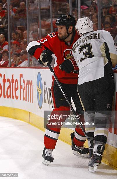 Jarkko Ruutu of the Ottawa Senators battles against the boards with Alex Goligoski of the Pittsburgh Penguins in Game 6 of the Eastern Conference...