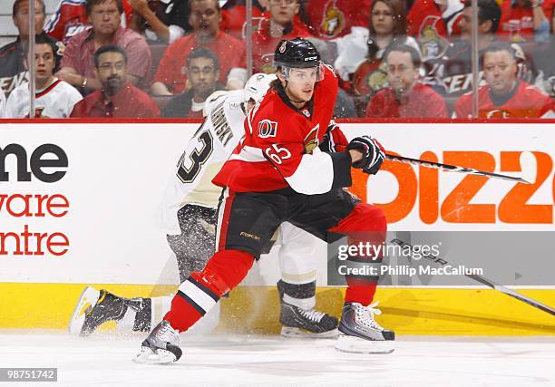 Erik Karlsson of the Ottawa Senators battles against the boards with Alexei Ponikarovsky of the Pittsburgh Penguins in Game 6 of the Eastern...