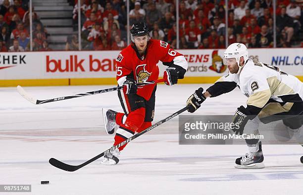 Erik Karlsson of the Ottawa Senators plays the puck as Pascal Dupuis of the Pittsburgh Penguins defens in Game 6 of the Eastern Conference...