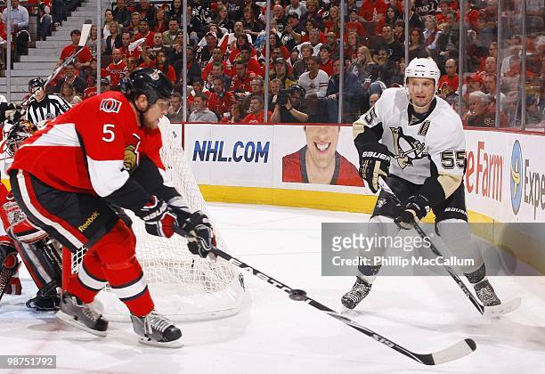 Sergei Gonchar of the Pittsburgh Penguins plays the puck as Andy Sutton of the Ottawa Senators defends in Game 6 of the Eastern Conference...