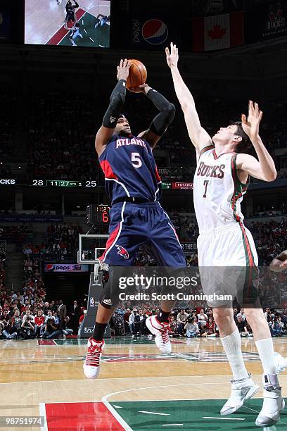 Josh Smith of the Atlanta Hawks shoots a jump shot against Ersan Ilyasova of the Milwaukee Bucks in Game Four of the Eastern Conference Quarterfinals...