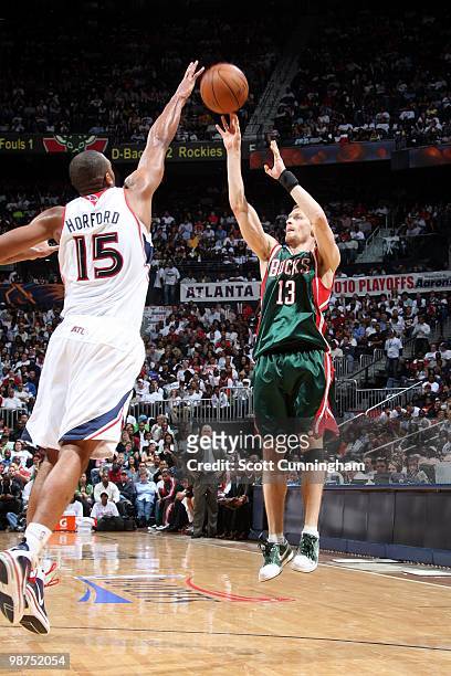 Luke Ridnour of the Milwaukee Bucks shoots a jump shot against Al Horford of the Atlanta Hawks in Game Five of the Eastern Conference Quarterfinals...