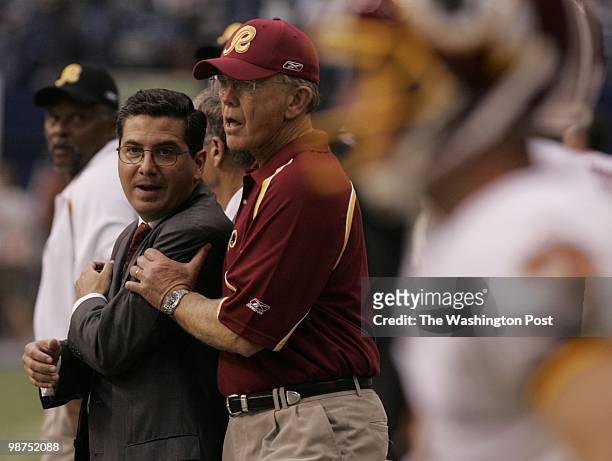 Washington Redskins head coach Joe Gibbs says hello to team owner Daniel Snyder as he comes onto the field for the start of the game against the...