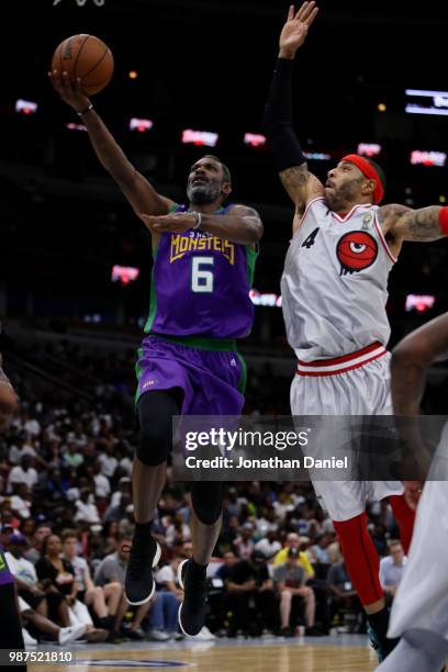 Mahmoud Abdul-Rauf of 3 Headed Monsters shoots against Kenyon Martin of Trilogy during week two of the BIG3 three on three basketball league at...