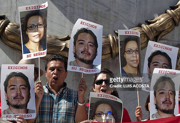 Journalists hold pictures of photographer David Cilia and journalist Erika Ramirez during a protest in Mexico City on April 29, 2010. Cilia and...