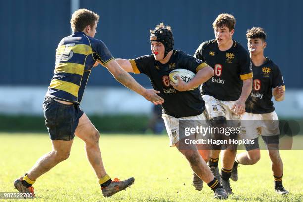 Geordie Bean of Wellington College fends Lucas Megaw of Wairarapa College during the schoolboys 2018 Wellington 1st XV Premiership rugby match...