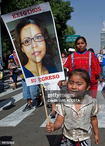 Native child holds the picture of journalist Erika Ramirez during a protest in Mexico City on April 29, 2010. Ramirez and photographer David Cilia...