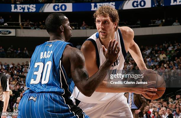 Dirk Nowitzki of the Dallas Mavericks moves the ball against Brandon Bass of the Orlando Magic during the game on April 1, 2010 at American Airlines...