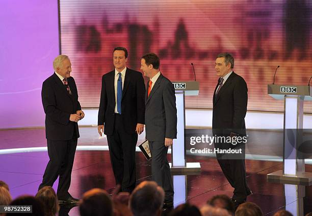 In this handout image provided by the BBC, Election debate moderator David Dimbleby , stands beside Conservative Party leader David Cameron Liberal...