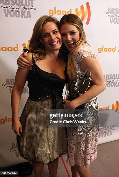 Actress Drew Barrymore poses with the 2010 Vanguard Award backstage alongside chef Cat Cora at the 21st Annual GLAAD Media Awards held at Hyatt...