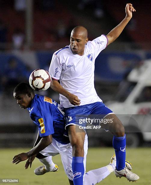 Uruguayan Nacional player Diego Vera vies for the ball with Brazilian Cruzeiro's Elicarlos during their Libertadores Cup football match in Belo...