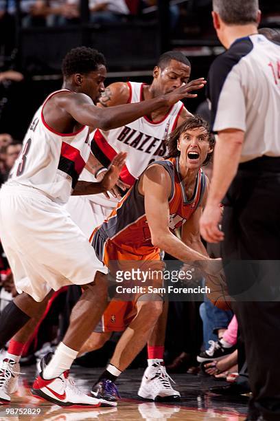 Steve Nash of the Phoenix Suns yells to the referee after being trapped by Martell Webster and Marcus Camby of the Portland Trail Blazers in Game...