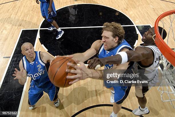 Dirk Nowitzki of the Dallas Mavericks grabs the rebound against Antonio McDyess of the San Antonio Spurs in Game Four of the Western Conference...