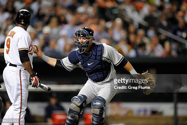 Miguel Tejada of the Baltimore Orioles is tagged out by Francisco Cervelli of the New York Yankees at Camden Yards on April 29, 2010 in Baltimore,...